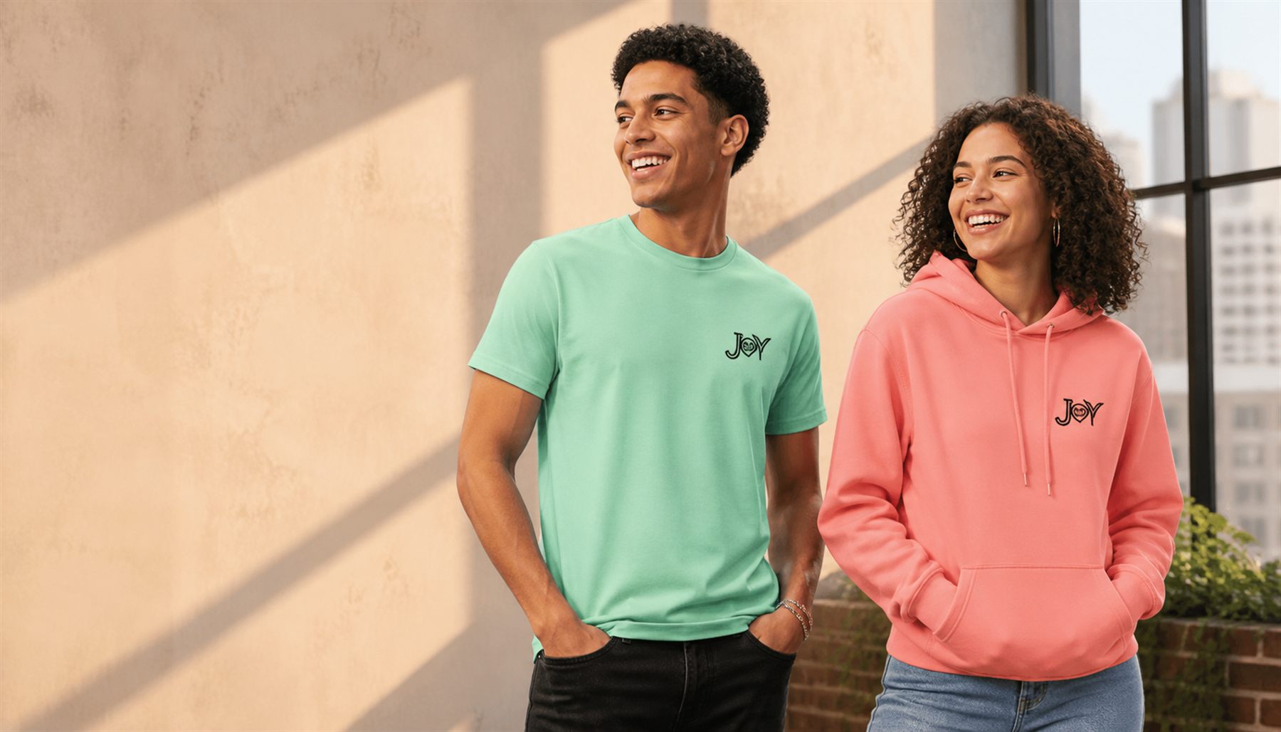 Two Joy Apparel models wearing a custom logo T-shirt and hoodie